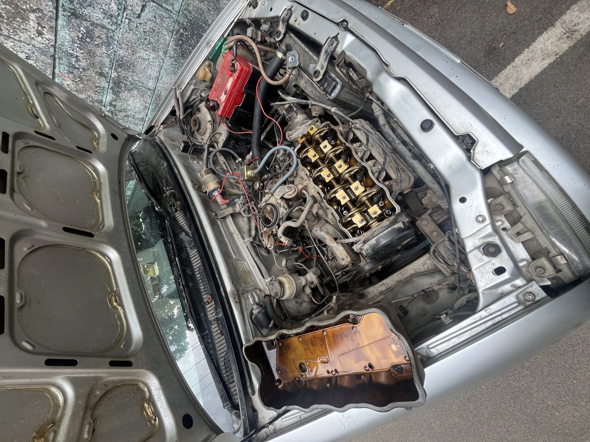 Engine bay fully open — valve cover removed